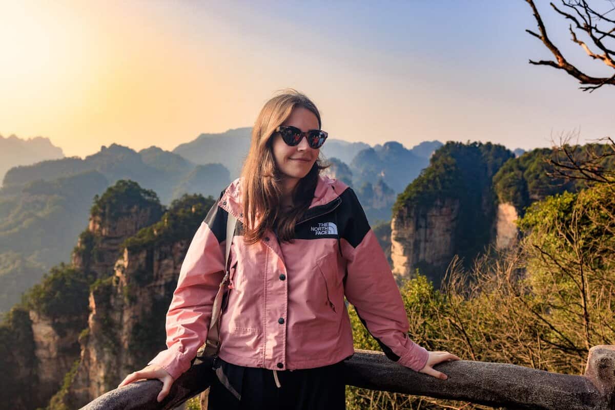 Woman enjoying scenic view of China's mountains during a tour with OlaChina.
