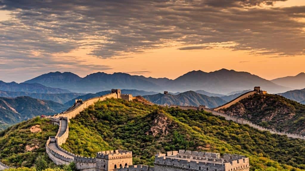 Iconic Great Wall of China at Badaling with mountain backdrop at sunset.