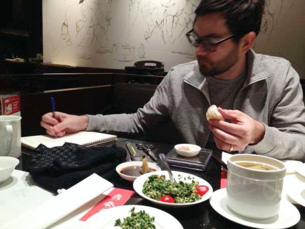 American chef using precision calipers to measure traditional xiaolongbao dumplings in an authentic Shanghai restaurant kitchen.
