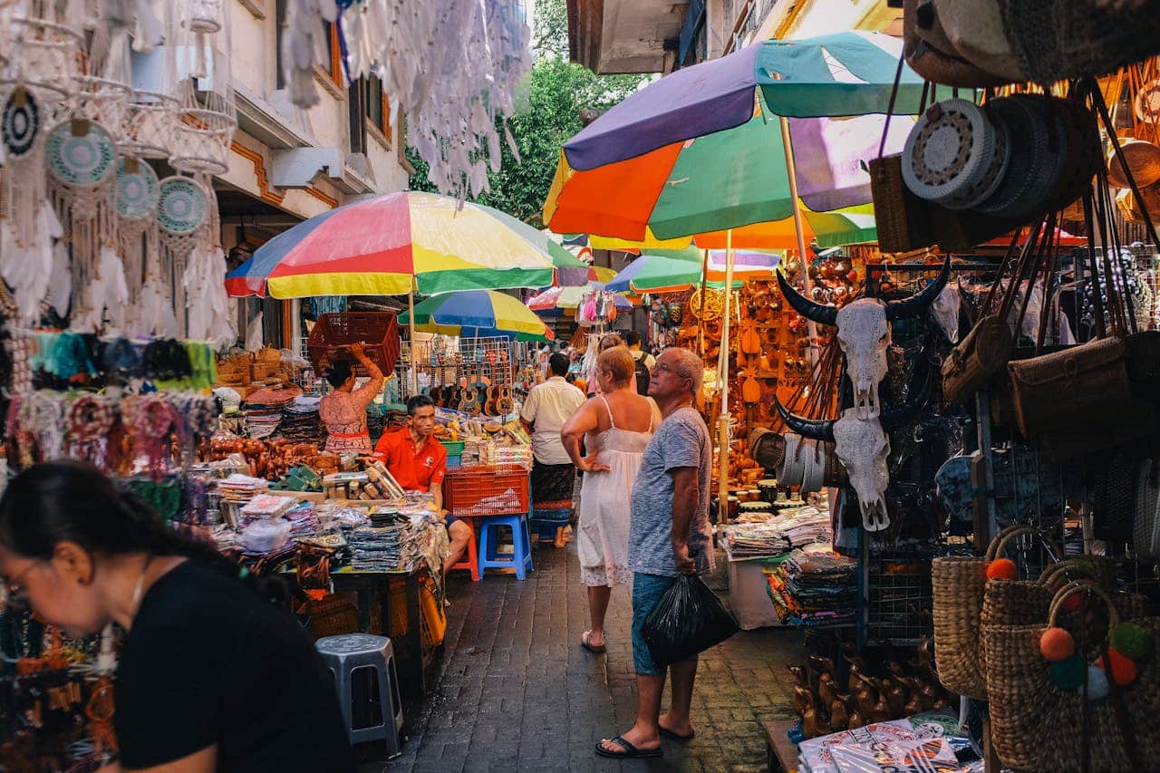 Foreign buyers browsing colorful product stalls at a busy wholesale market in China