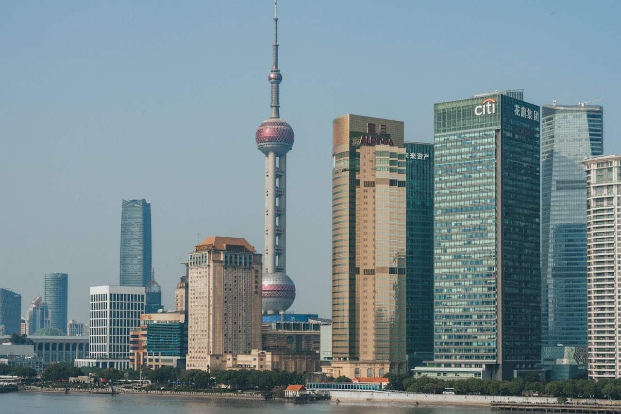 Shanghai Pudong skyline featuring the Oriental Pearl Tower and Lujiazui financial district skyscrapers in daytime.
