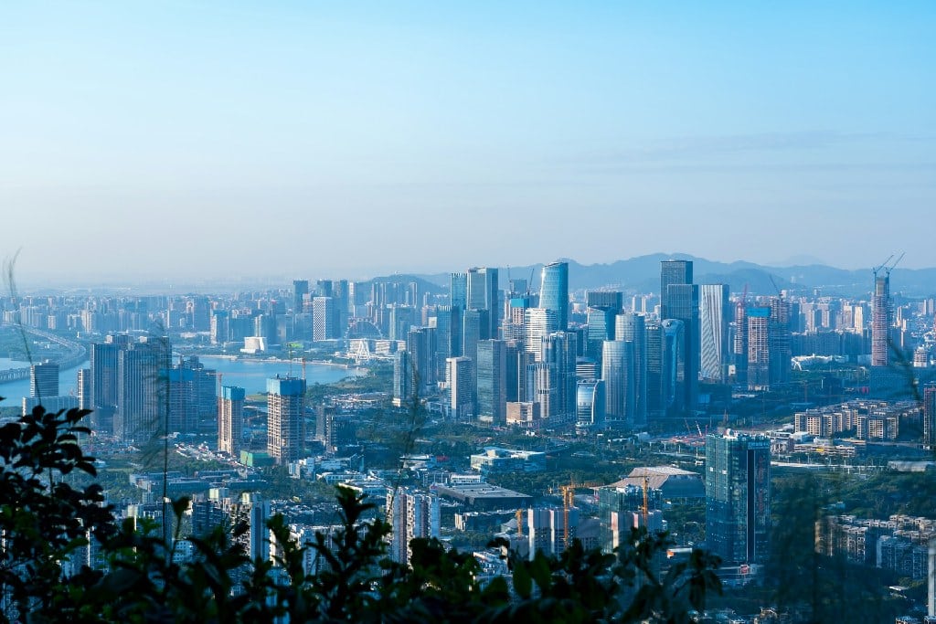 Aerial view of Guangdong cityscape stretching across the Pearl River Delta, seen from elevated ground