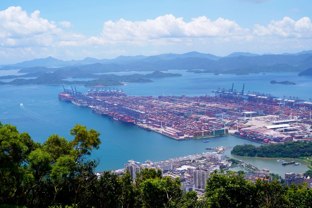 Aerial view of a busy Chinese container port with cranes and cargo ships