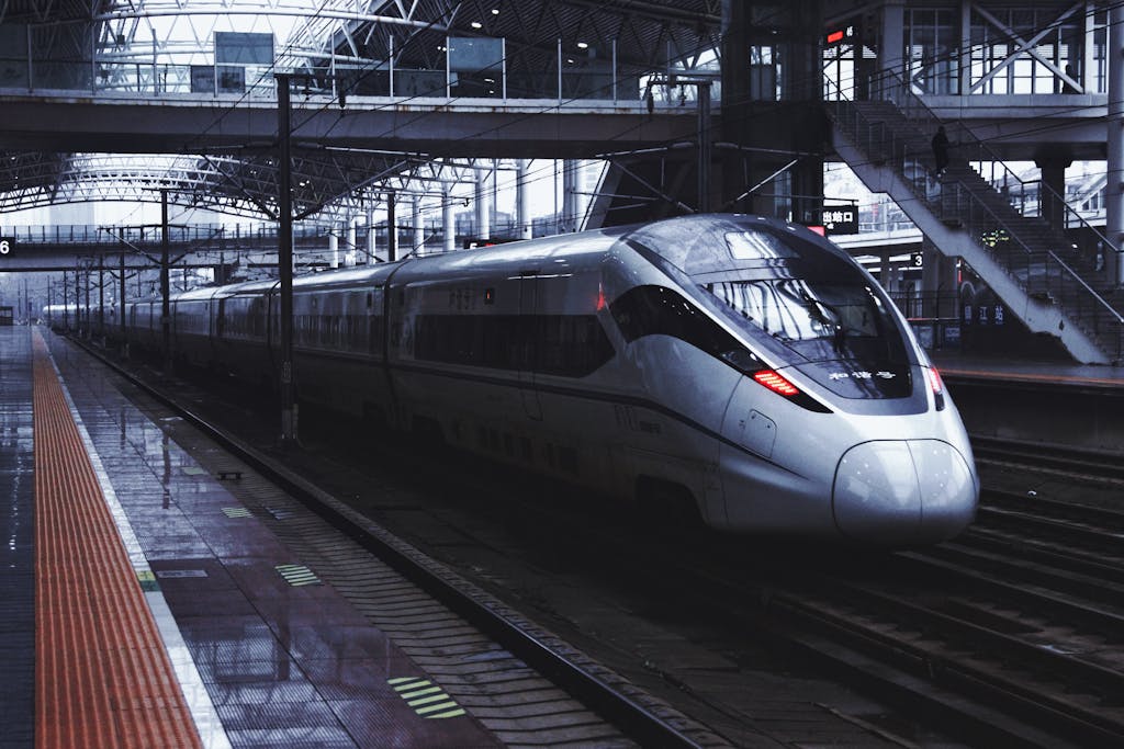 Silver high-speed train waiting at a covered station platform on a new line into China's Hakka heartland